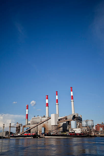 istock Three smoke stacks from a power plant near the water 182382703