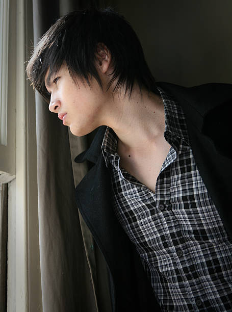 istock Male model looking out window in thought. 182383599