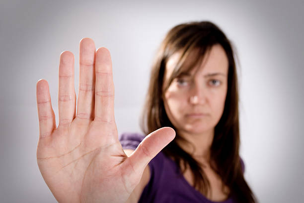 istock Woman holding up her palm in a stop gesture 182384690