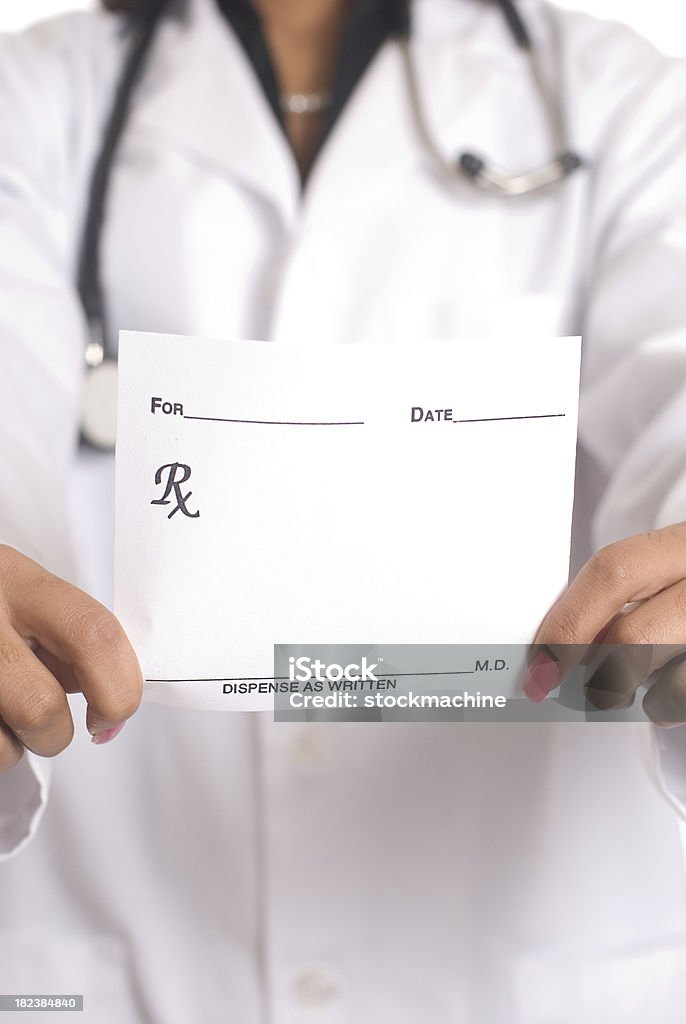 Prescription For You Female doctor holding out blank prescription note toward the camera.  Studio shot. Close-up. Note Pad Stock Photo