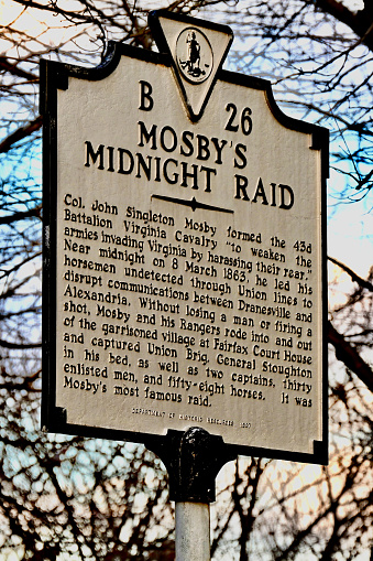 Fairfax, Virginia, USA - November 30, 2023: A Virginia Department of Historic Resources metal sign in the City of Fairfax tells the history of “Mosby’s Midnight Raid”, a well-documented event from the American Civil War.