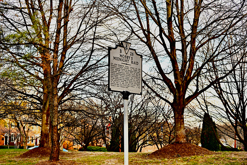 Fairfax, Virginia, USA - November 30, 2023: A Virginia Department of Historic Resources metal sign in the City of Fairfax tells the history of “Mosby’s Midnight Raid”, a well-documented event from the American Civil War.