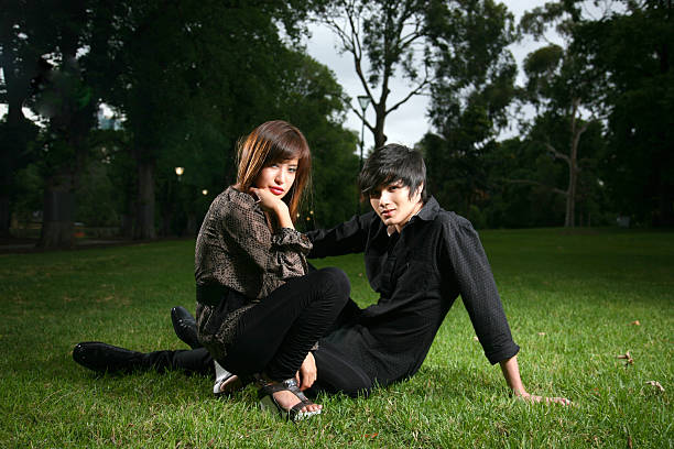 young asian couple enjoying the park on dusk
