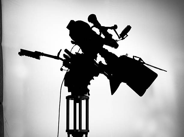 istock silhouette of movie camera on set 182385488