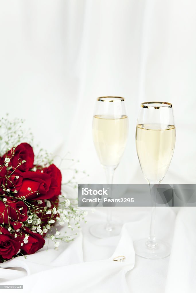 Dozen Red Roses for Valentines Day Series red roses with engagement ring and champagne of white satinCheck out my Love & Valentine's Series Bouquet Stock Photo