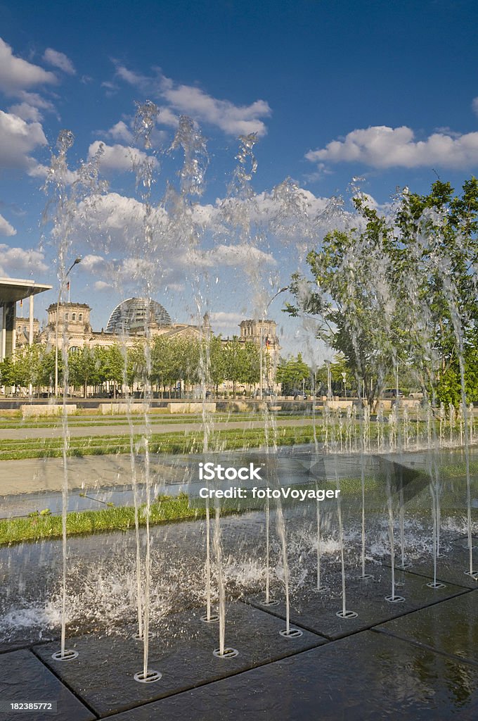 Berlin Reichstag parliament buildings summer fountains Platz der Republik Germany "Big blue skies and white fluffy clouds over the fountains and esplanade of the Platz der Republik, the Bundestag buildings and the iconic facade and dome of the Reichstag in the heart of Berlin. ProPhoto RGB profile for maximum color fidelity and gamut." Fountain Stock Photo