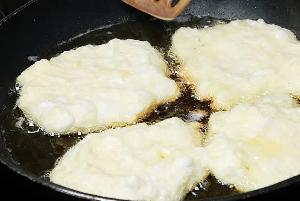 pancakes made out of potatoes called Reibekuchen, frying in a pan, german special recipe