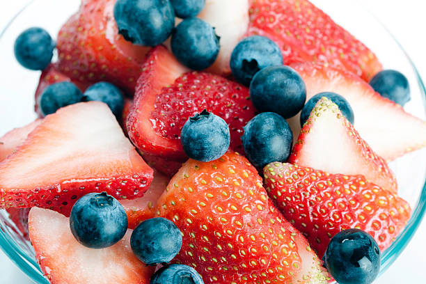 istock Strawberries and blueberries in a bowl 182386075