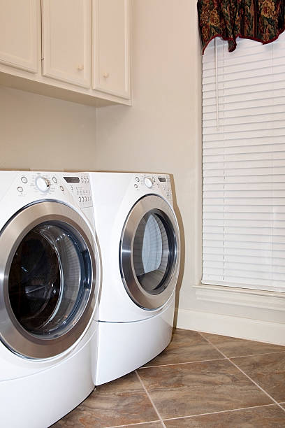 istock Washer, dryer. Utility, laundry room. Home. Front load, energy efficient. 182386848