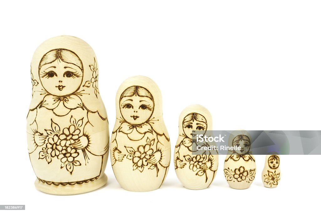 Unpainted Matryoshka dolls "Five unpainted, wood burned, Russian Matryoshka dolls arranged in order of decreasing size." Adult Stock Photo