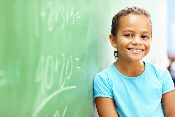 istock Little school girl leaning on board 182387009