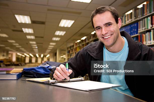 Happy College Student Studying And Writing In Library Stock Photo - Download Image Now