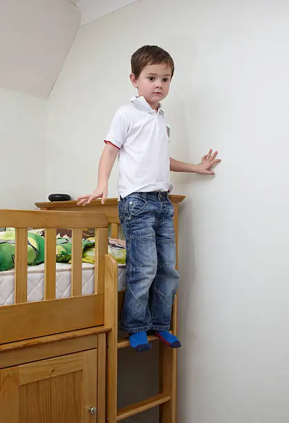 Five year old climbing down from bunkbed