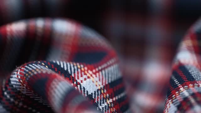 costume fabric with checkered pattern. scottish plaid red white blue fabric. closeup rotation.