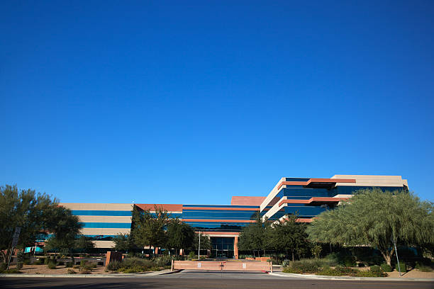 Modern Scottsdale Business Scottsdale Arizona business building modern office complex 20th century style on a clear day with evergreen trees set on a bright blue clear sky background southwest usa architecture building exterior scottsdale stock pictures, royalty-free photos & images
