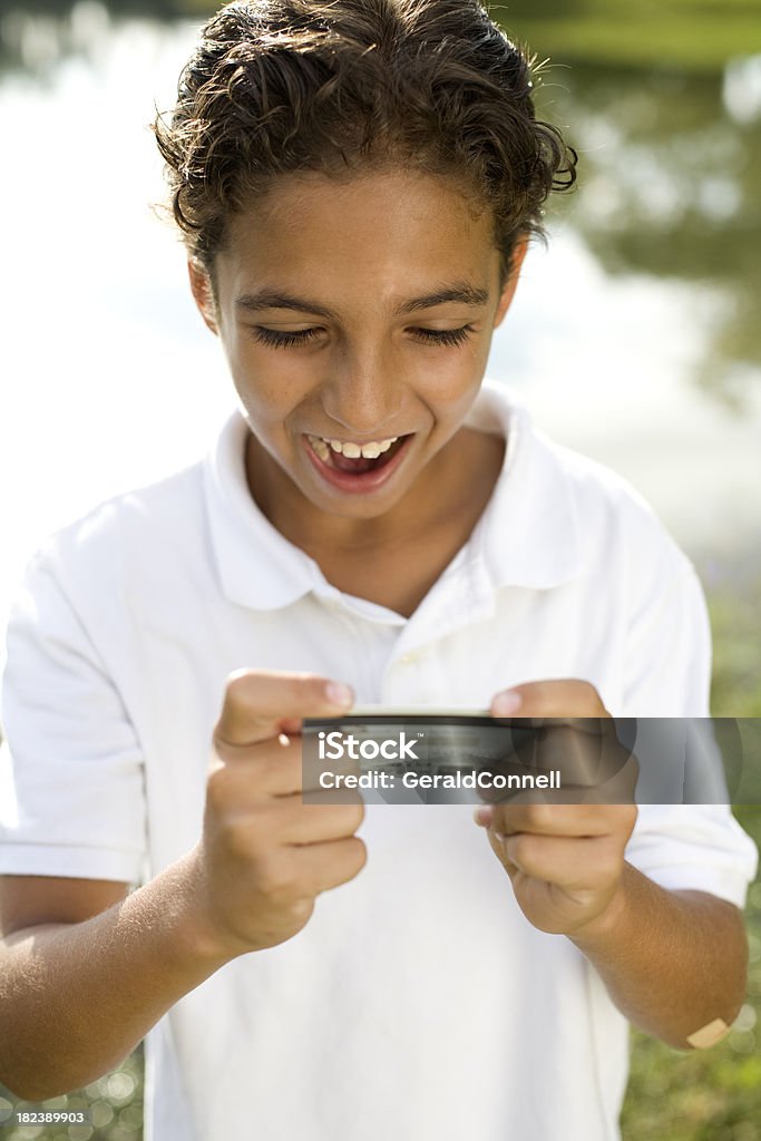 Boy Holding Credit Card Yong Boy Holding a Credit Card with a Happy Expression Accessibility Stock Photo