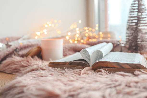 Open Bible in cozy pink winter home morning atmosphere Open Bible in cozy pink winter home morning atmosphere. book heart shape valentines day copy space stock pictures, royalty-free photos & images