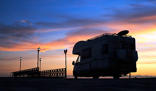 istock Caravan on the road and bridge at sunset 182391266