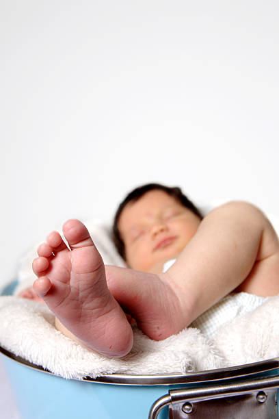Close-up of feet of new born baby with prick marks stock photo