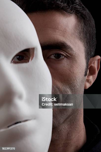 Adult Man Peeking Behind Mask In Vertical Composition Stock Photo - Download Image Now