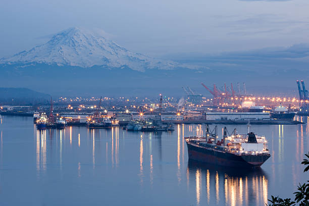 A photo of port Tacoma and a snow topped Mount Rainier Port of Tacoma With Mount Rainier In Background at dusk tacoma stock pictures, royalty-free photos & images