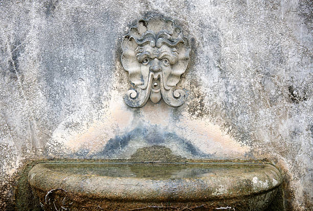 istock Old Weathered Stone Fountain w Face 182392077