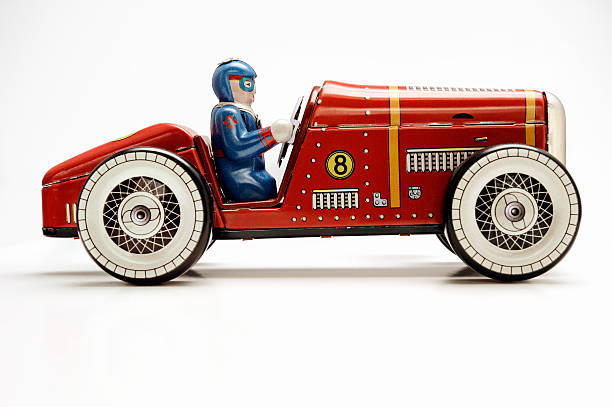 clockwork vintage toy racecar Vintage old red clockwork racecar made of tin isolated on white. porsche classic sports car obsolete stock pictures, royalty-free photos & images