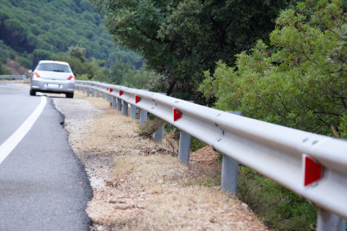 Car flashing hazard lights on italian mountain road