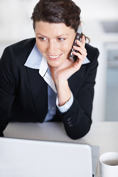 istock Smiling businesswoman talking on a cellphone 182392698