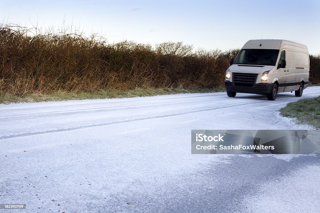 white van on icy road Van - Vehicle Stock Photo