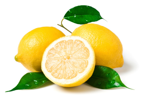 Whole and half sliced lemon with green leaves isolated on white background. Top view. Flat lay.