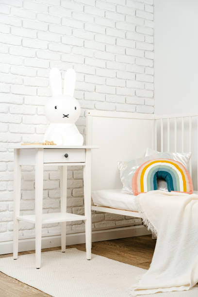istock Kid's room interior with comfortable bed and rainbow pillow 1823929054
