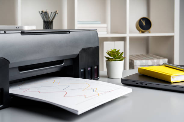 istock New modern printer and laptop in the office on table 1823929069