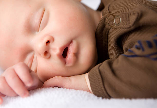 istock Newborn sleeping soundly with mouth open 182393351