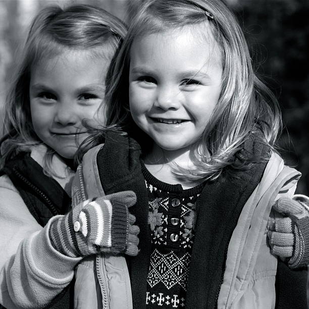 Twin Girls posing in the leaves