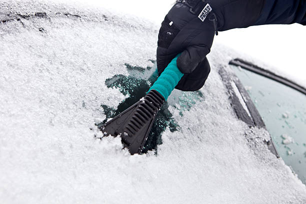 istock Gloved Hand Scraping Snow and Ice from a Car Window. 182394889