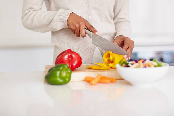 istock Mid section of a lady cutting vegetables 182394895