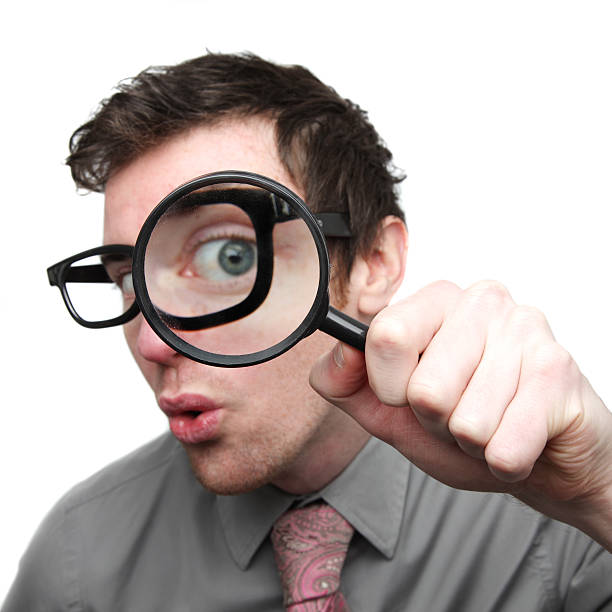 istock Businessman searching with magnifying glass 182394928