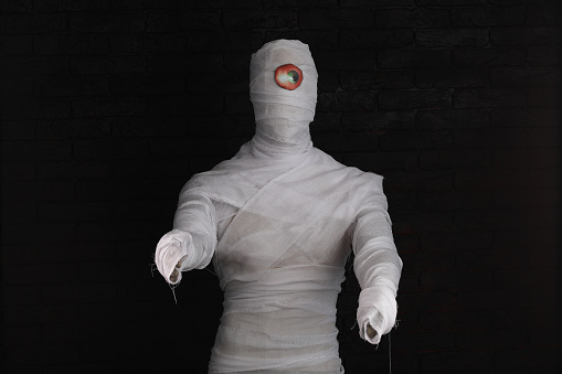 mummy in bandages on a black background