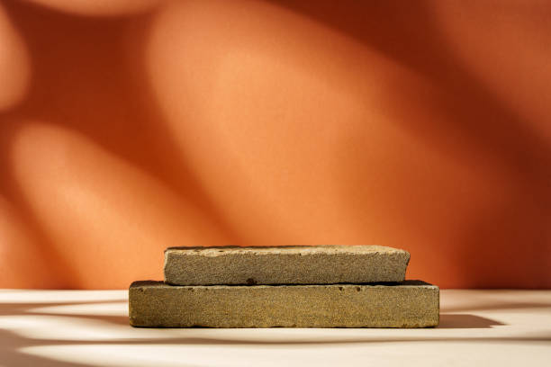 istock Piece of granite stone against beige background with shadows 1823958434