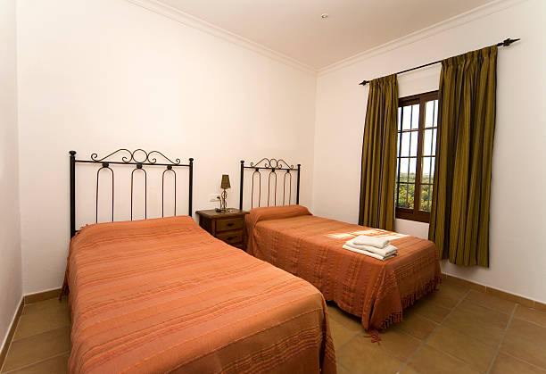 istock Hotel bedroom with twin single size beds 182396075