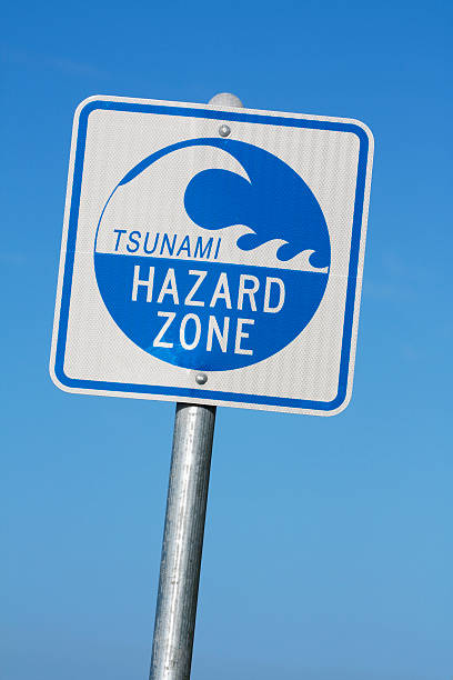 Tsunami hazard zone warning sign against blue sky in Northern  California.