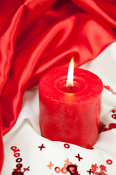 Valentines Day Candle "Candle with red, white satin and X, O's and heart shapesCheck out my Love & Valentine's Series" flaming o symbol stock pictures, royalty-free photos & images