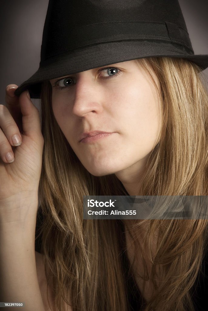 Beautiful young woman wearing fedora hat looking at the camera Beautiful young woman wearing fedora hat looking at the camera. You might also be interested in these: 20-29 Years Stock Photo