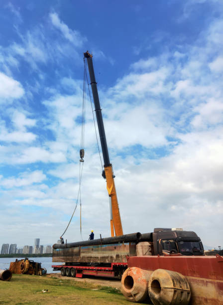 istock A crane lifting pipes in a warehouse 1823973188