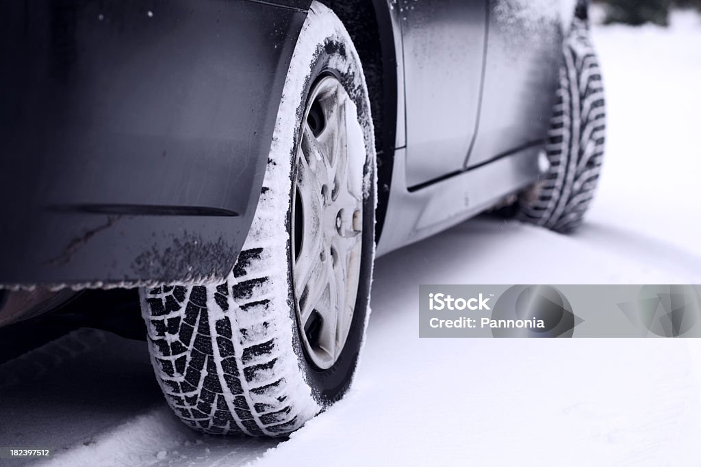 Car tires leaving a track in the snow Car tires in snow Tire - Vehicle Part Stock Photo