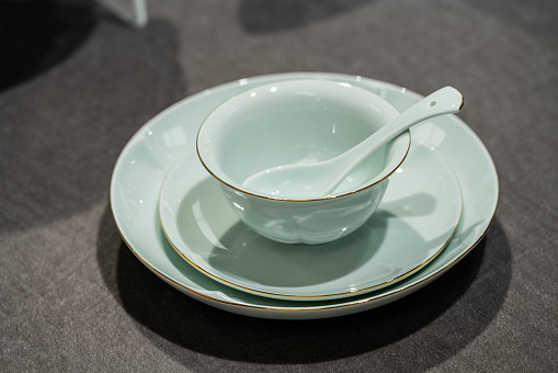Traditional Chinese restaurant tableware: spoons, plates and bowls.