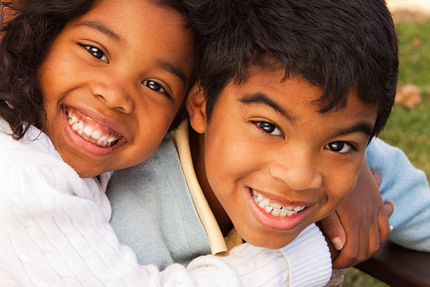 istock Brother and sister hugging 182397807