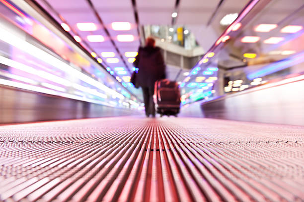 istock Blurry businessman traveling on horizontal escalator 182398403