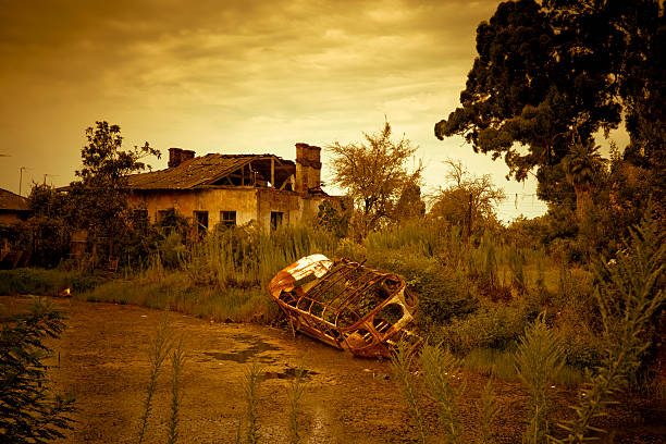 Abandoned house with old bus in swamp. Slight toned in sepia and vignetting effect.